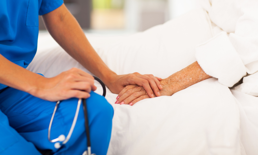 Nurse Assisting Patient In Bed Image